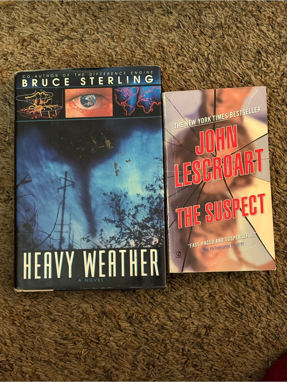 Heavy Weather by Bruce Sterling - The Suspect by John Lescroart. GUC.